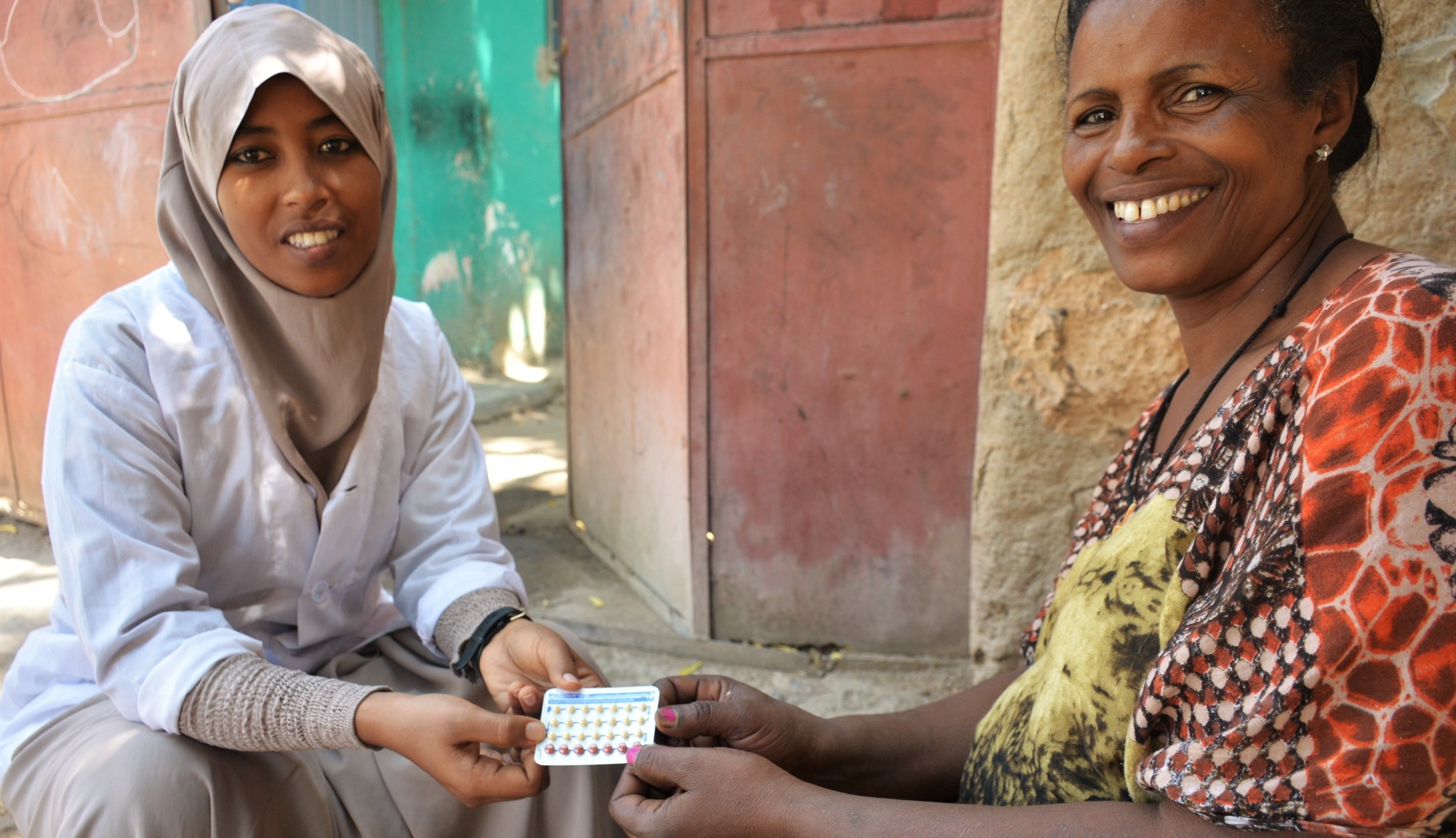 Clinician Zebiba Abdizein (left) and family planning client Mulu Feke (right) chat about family planning services