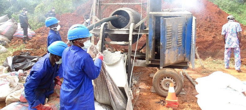 Employees of a local service provider trained by GHCS-TA Francophone TO in safe pharmaceutical waste management are neutralizing counterfeit pharmaceuticals prior to final disposal at an approved landfill site. Photo credit: Chemonics