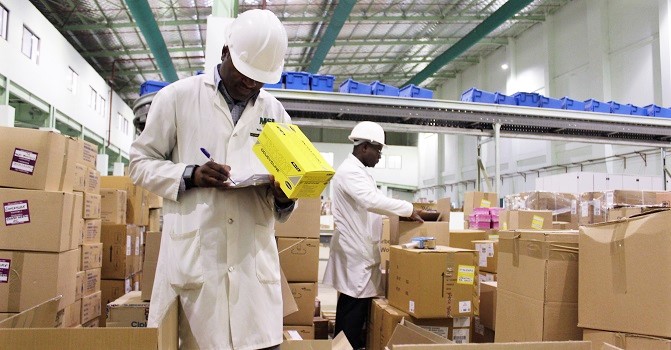 Men with boxes in Zambian warehouse