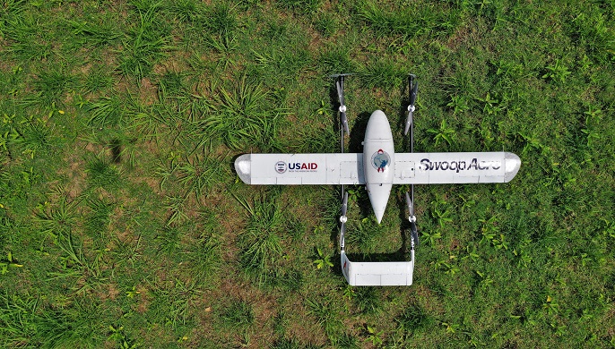 Image of the top of a drone that is on the ground.