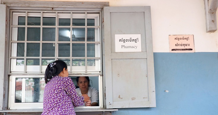 Patient picking up medication at Cambodia pharmacy