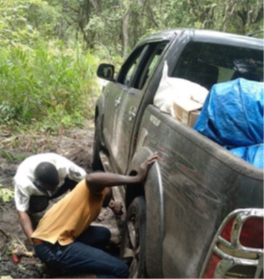 Octávio Longuenza and Paulino Mbundo dig their pick-up truck out of the mud in Lunda-sul Province, Angola. 