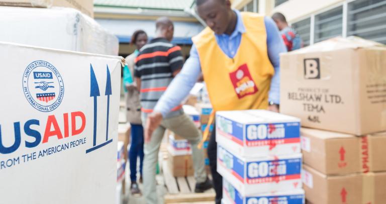 A man unloads USAID-branded boxes